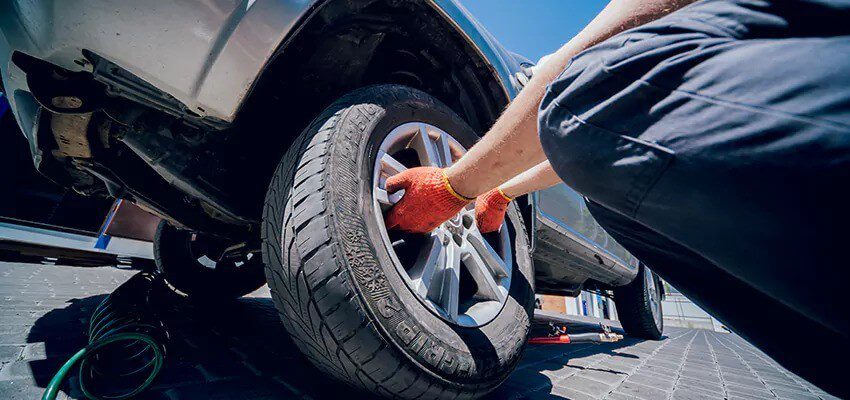 Zak Towing roadside assistance truck helping with a flat tire change and repair in Calgary