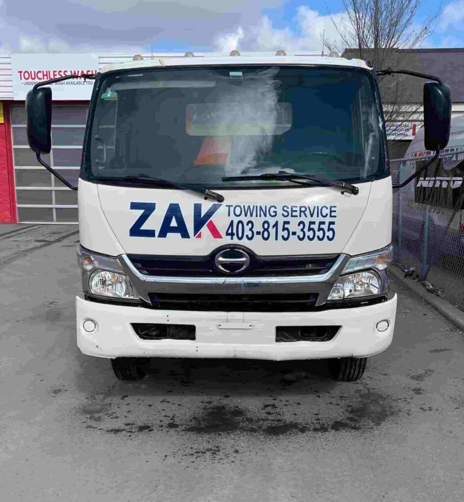 Zak Towing Service tow truck with company branding and contact number in Calgary