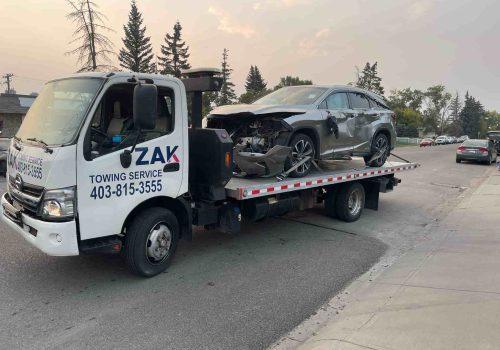 Zak Towing Service flatbed tow truck transporting a damaged SUV after an accident in Calgary, Alberta. Fast and reliable emergency towing and roadside assistance, ensuring safe recovery and transport ...Sorry but this string is too long !!!