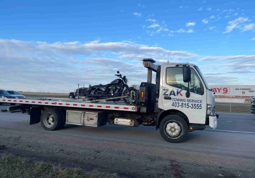 Zak Towing truck transporting a motorcycle safely in Calgary